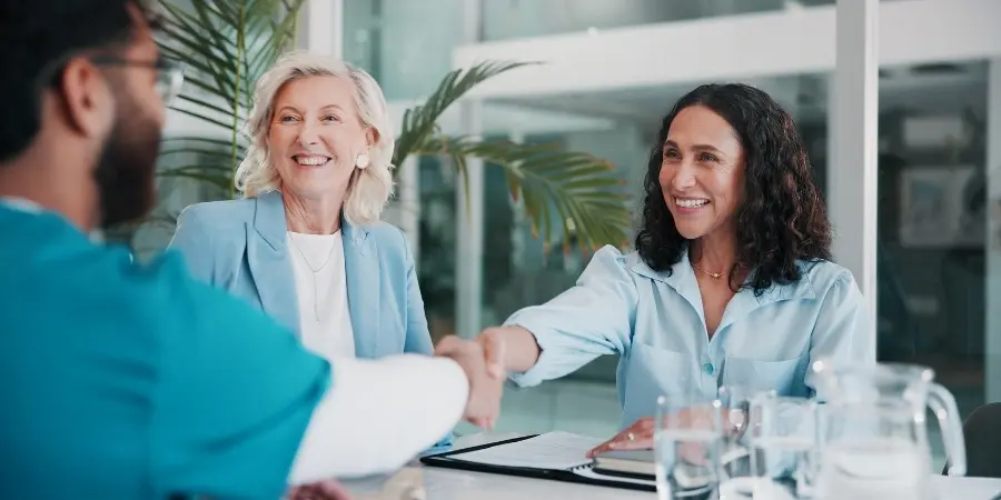 Male healthcare leader interviewing female practitioner